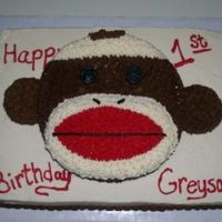 Sock Monkey Birthday Cake This was a 1/2 sheet cake with a round and 2 cupcakes on top to make the sock monkey. The family loved it! All done in buttercream.