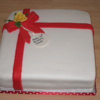 Birthday Present chocolate cake with ganache covered with fondant ribbon & sugar rose