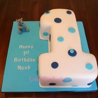 No.1 Birthday Cake No.1 shaped from a 9" square vanilla sponge cake, filled with IMBC and raspberry jam and covered with sugarpaste (fondant). Hand-...