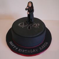 Ozzy Osbourne Cake 9" chocolate cake, cake covered in black sugarpaste (fondant). The figure is made from modelling paste.