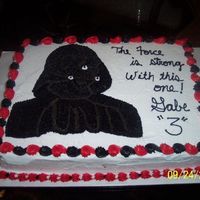 Darth Vader This picture doesn't do the cake justice. The lighting is off and DV looks like a black blob. In person, he is actually trimmed in a...