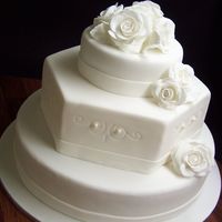 Simple Wedding Cake Apart from the roses, this cake took hardly any time (because the bride wanted all white). All fruit cake with fondant accents.