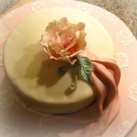 Img_3703.jpg First shot at gumpaste and am fairly pleased with the results. The cake itself is missing something. Really I just wanted someting to set...