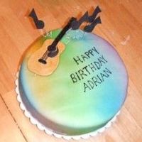 Guitar Birthday Cake This is a cake made for a 19-year-old boy. The cake is covered in fondant and sprayed with different color Colormist. The guitar is made...