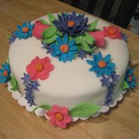 My Daughter's 2Nd Birthday Cake The cake is covered in fondant and the flowers are gumpaste. This was my first attempt at gumpaste flowers. I made it for my daughter'...