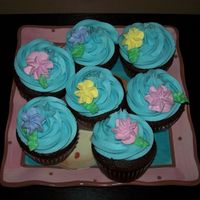 Cupcakes Chocolate cupcakes with swirl of BC, topped with royal icing drop flowers.