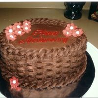 Anniversary Cake Chocolate buttercream basketweave cake with royal icing flowers.