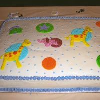 Baby Shower Cake was done to match napkins and plates for a friends baby shower. It was my first attempt at making a big cake and it cracked a little...