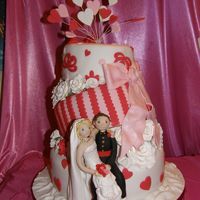 Topsy 2 Three tier topsy cake with sugar flowers and bows.Bride and Groom [soldier]