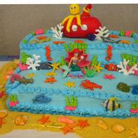 Under The Sea Cake I made for my 3 daughters BD. Shells, starfish, submarine, octopus are fondant. The fish are plastic figures. Coral is royal icing....