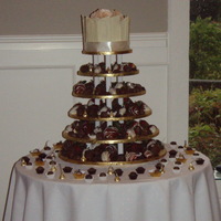Wedding Cupcake Tower Choc dipped strawberries and choc truffles with a cutting cake on top.