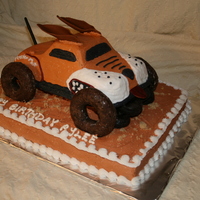 Monster Mutt 1/2 sheet cake on bottom with brown sugar dirt. Monster Mutt vehicle was yellow cake with chocolate donut wheels, fondant tail, ears, and...