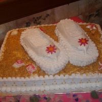 Flip Flop Bride 1/2 sheet cake with flip flop shaped cakes on top. Straps are made out of fondant and painted with luster dust. Icing is b/c, seashells are...