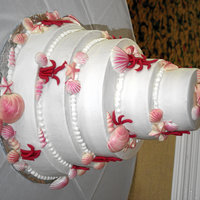 Seashell Wedding Cake Two tiers of this cake were almond buttermilk with almond icing and the other two were yellow cake with orange flavored icing. The...