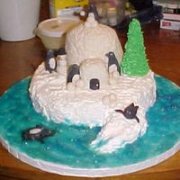 Penguin Playland My 13 year old son made this for the festival and won 1st place. The water is piping gel colored blue. The tree is a sugar cone (ice cream...