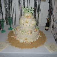 Colorful Seashell Wedding Cake This is the second white chocolate seashell wedding cake I did. I tinted the seashells to match the wedding invitations.