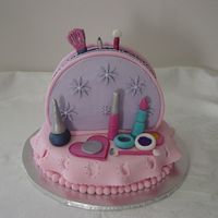 Make Up Bag I made this cake for a 6 year old little girl's Birthday. The bag was iced with buttercream the decorations are mmf and the tablecloth...
