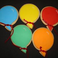 Balloon Cookies NFSC covered with rolled fondant, RI white shimmer line and a red rope licorice tied at the bottom before bagging. I saw the licorice idea...