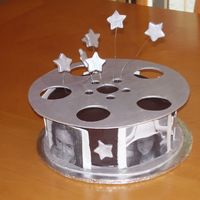 Movie Themed Cake Chocolate cake with chocolate buttercream. I used the birthday girl's pictures as the "movie" strips.Thanks to CC'er...