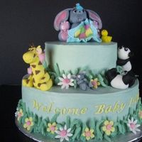 Jungle Baby Dummy Cake WASC cake with cream cheese buttercream. Fondant/gumpaste animals. There is a sleeping lion on the back. My first attempt at animals!