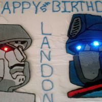 Transformers Cake I made a chocolate chocolate chip cake with cream cheese buttercream icing. This was my first time using the royal icing transfer technique...