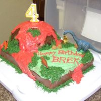 Volcano Dinosaur Cake My son wanted a volcano cake. I used Betty Crocker Bake 'n Fill dome pan to make the volcano. Inside the volcano was whipped cream. I...