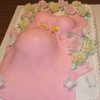 Shannon's Belly Cake Half sheet cake with buttercream icing, fondant dress and sugar paste roses and butterflies.