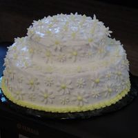 Daisy Cake white buttercream icing with sugar paste daisies with royal icing centers.