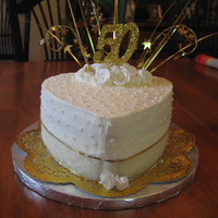 50Th Anniversary Cake Small heart shaped cake for a 50th anniversary.First attempt at the sugar pearls. Real ribbon on the bottom.