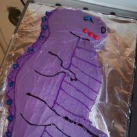 Purple Dinosaur Used the partysaurus pan and gel icing for the details. Hersey Kissables for the spikes.