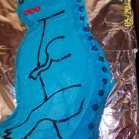 Blue Dinosaur Used the partysaurus pan and gel icing for the details. Hersey Kissables for the spikes.