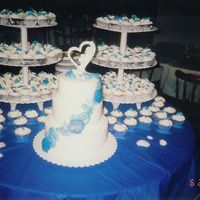 Wedding Cake First wedding cake! A 6" & 8" carrot cake and 10" dummy. Shells are made of white chocolate molds colored different...