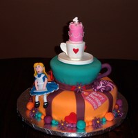 Mad Hatter Tea Party Cake Fondant and chocolate clay decorations. Teacup on top is made of chocolate.