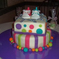 Baby Shower Cake I made this cake for my sister's baby shower. The sneakers and charm bracelet are made of fondant, and the charms on the bracelet are...