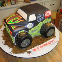 Grave Digger Truck covered in fondant with hand painted and fondant details. tires are modelling chocolate.