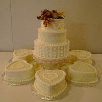 Sheilas Wedding Cake Small 3 tier cake with small heart shaped cakes around the bottom