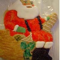 Santa Cookie Before the cookies were baked I used egg yolk with brown food coloring to wash the basket areas of the cookie and green for the bow. Then...
