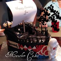 Buccaneers Ship This cake was a nightmare. Extremely humid out, so the choc fondant was melting, Was not able to finish the cake due to everything sliding...