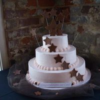 Pink And Brown All-star graduation party. Buttercream with fondant stars. Gumpaste/fondant mix for star atthe top and banner.