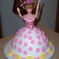 Barbie iced with buttercream, apple blossoms were used to decorate the dress the border was made out of apple blossoms and prim roses the top of...