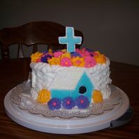 Course 2 Basket Weave Cake buttercream icing with basket weave and royal icing flowers on top the cross, birds, and house are made from color flow