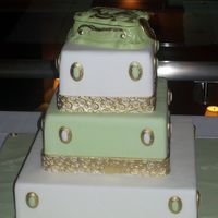 100_2355.jpg This cake was entered as my first time entry into a cake show. Covered in fondant with a chocolate keepsake box as a topper