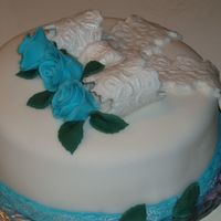 P8160041.jpg First time using fondant. Part of it is homemade fondant too. Dark Chocolate Cake with Raspberry filling.