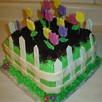 Tulip Garden 8" cake, fence and tulips are gumpaste, everything else is fondant, oreo for dirt. TFL.