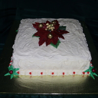 Christmas Cake - 2009 This was a simple 12" Red Velvet w/cream cheese square for work. Gumpaste Poinsettia