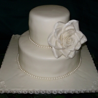 Ivory With Pearls And Large Rose Simple ivory with pearls and large rose. Amaretto with buttercream covered in chocolate fondant.