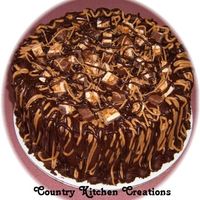 Chocolate And Caramel Snickers Cake Triple Chocolate fudge cake torted with chocolate and caramel icing- frosted with chocolate fudge icing and drizzled with caramel and...