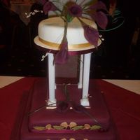 Burgundy Calla Lillies Customer wanted a traditional style wedding cake, but with contemporary colouring. Think that the combination of burgundy, gold & ivory...