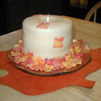 Candle Inspired by all the candle cakes I have seen on CC. Three 6 inch white cakes with raspberry filling. Covered in MMF and fondant leaves.