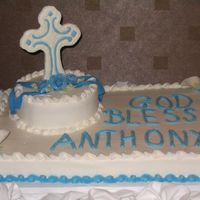 Anthony's First Communion All the flowers and the ribbon are gumpaste. The cross was made out of color flow and two matching crosses were "glued" together...